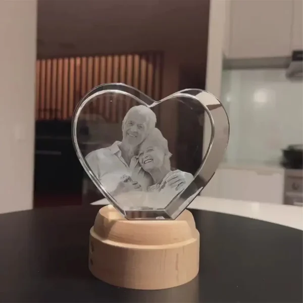 A real-life photo of the YiYues 3D Heart Crystal Lamp on a dining table in a customer's home, showing its authentic, unedited appearance.
