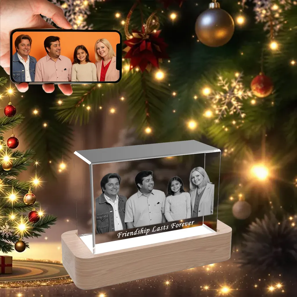 A horizontal 3D photo crystal engraved with a picture of four friends and "Friendship Lasts Forever," displayed as a Christmas gift in front of a festive tree.