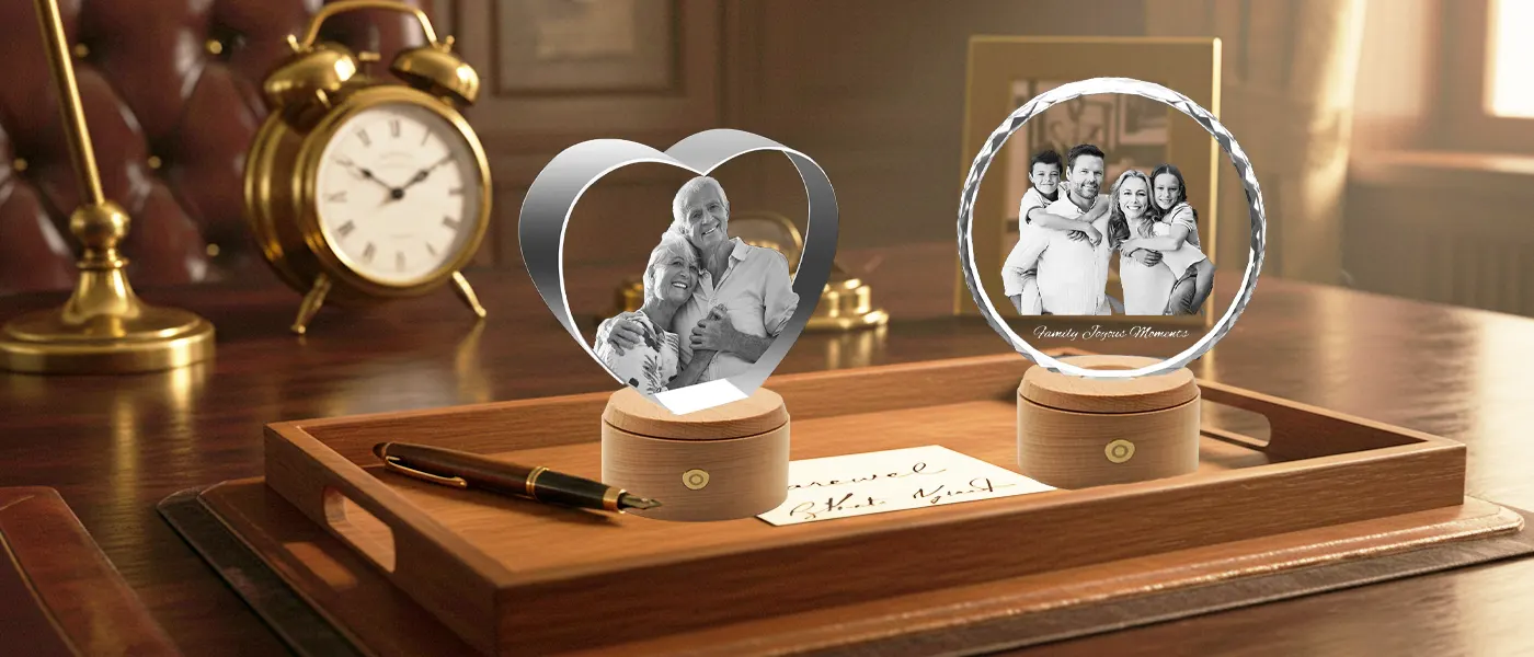 Two personalized 3D photo crystal gifts, displaying family and couple portraits, arranged on a classic wooden executive desk as a sophisticated retirement gift or keepsake.