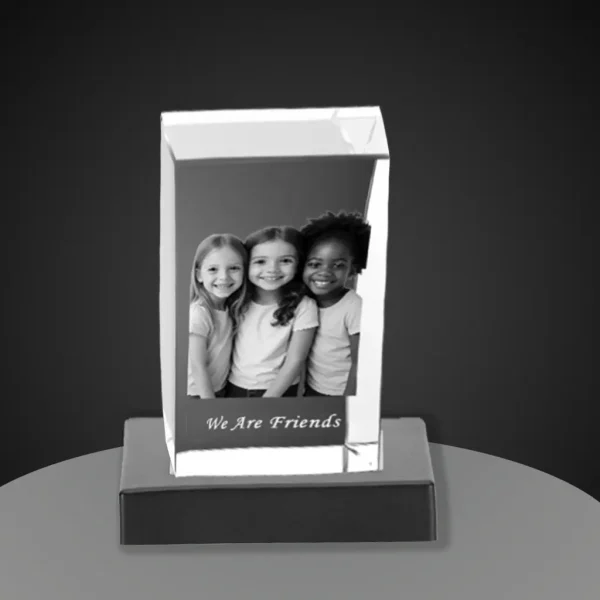 YiYues Personalized 3D Rectangular Crystal Block on a modern black base, featuring a custom photo of three young friends and the engraving 'We Are Friends'.