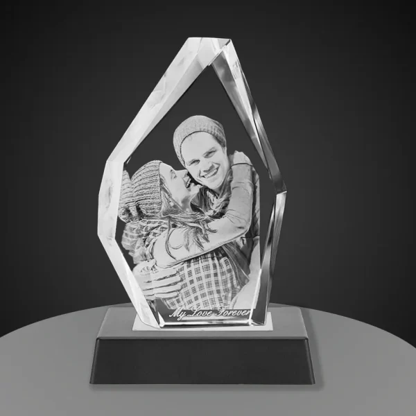 YiYues Personalized 3D Crystal in a modern iceberg shape, showcased on a sleek trapezoid black base with the custom engraving 'My Love Forever'.