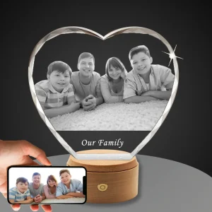 YiYues Personalized Faceted 3D Crystal Heart featuring a custom family portrait of parents with their two sons, with 'Our Family' engraved, on a classic wooden LED base.